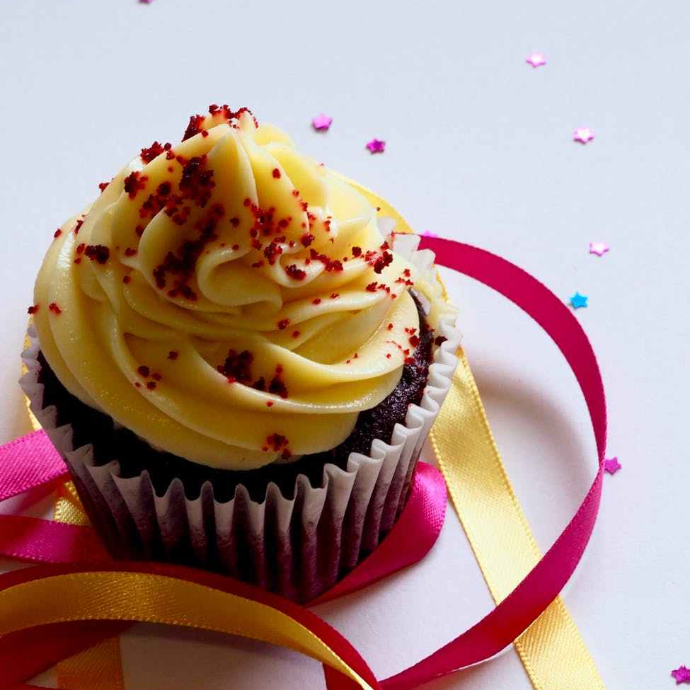 chocolate cupcake with white and red toppings