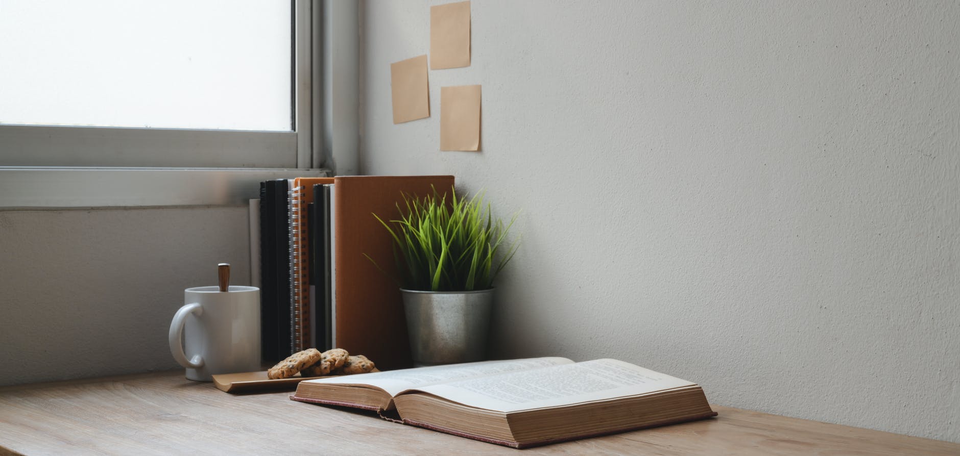 brown hardbound book on brown wooden table