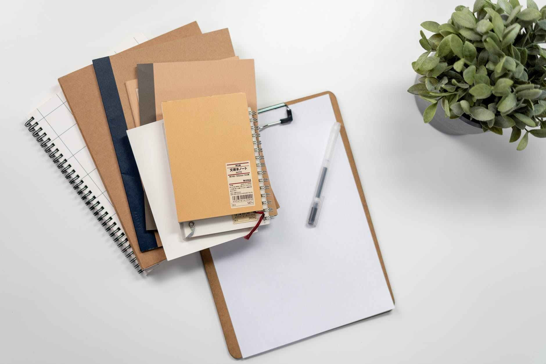 brown folder with black pen on white table